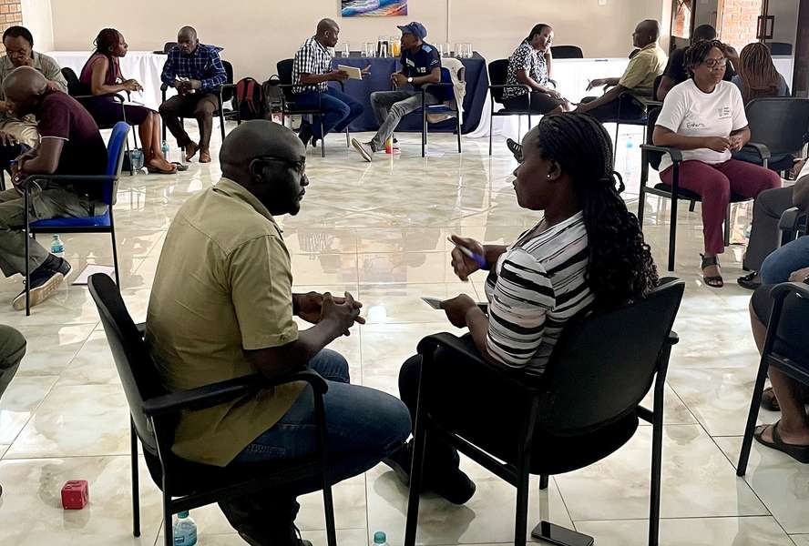 Participants exchange ideas during a P-FIM (People First Impact Method) exercise in Bindura, Zimbabwe, in November 2023. P-FIM involves communities in the planning of humanitarian assistance.