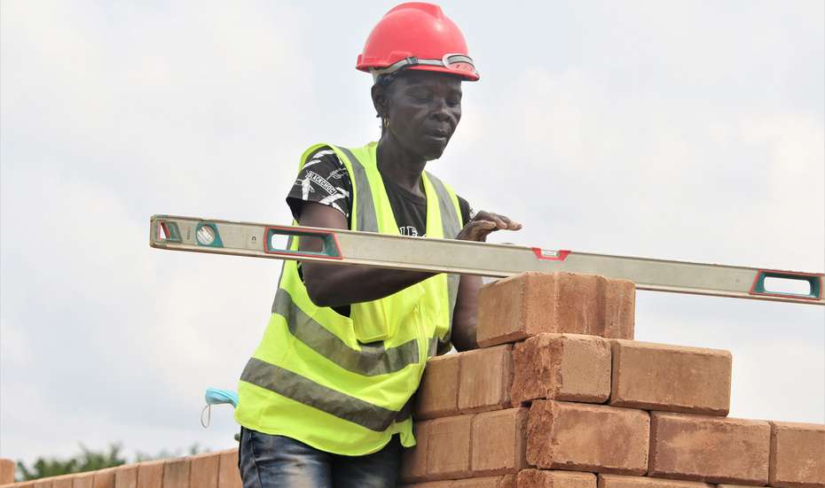 A female bricklayer building healthcare facilities in Liberia
