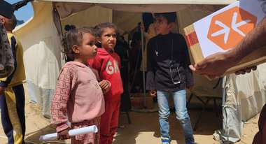 Children in a refugee camp in Gaza during the distribution of relief supplies